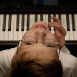 Aerial view of Luke playing piano.