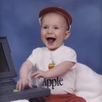 Luke as a baby with an Apple computer.